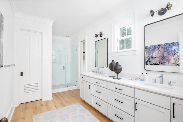 202 Bank St, Mount Pleasant, SC 29464 - bathroom featuring double vanity, wood finished floors, a stall shower, and ornamental molding