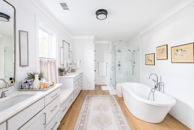 202 Bank St, Mount Pleasant, SC 29464 - bathroom with a stall shower, vanity, wood finished floors, a soaking tub, and ornamental molding