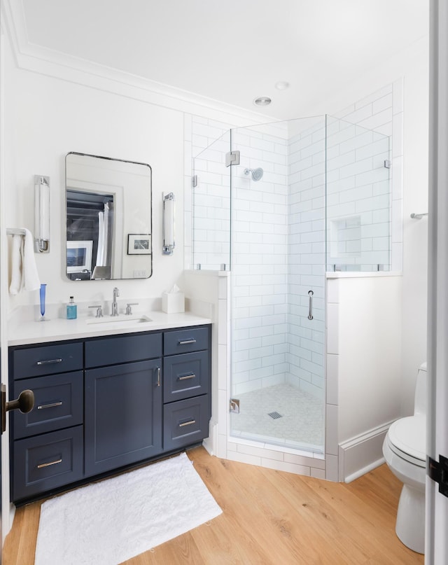 202 Bank St, Mount Pleasant, SC 29464 - bathroom featuring wood finished floors, toilet, a stall shower, vanity, and crown molding