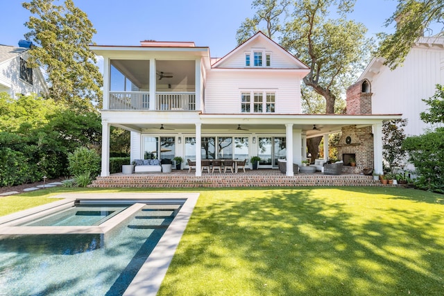 202 Bank St, Mount Pleasant, SC 29464 - back of property featuring a ceiling fan, an outdoor living space with a fireplace, and a yard