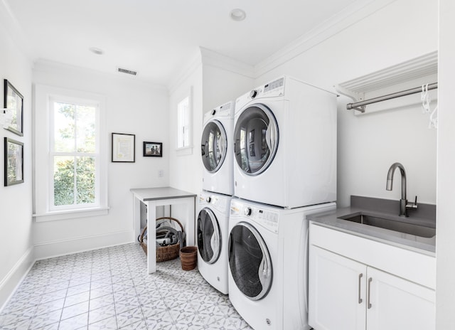 202 Bank St, Mount Pleasant, SC 29464 - laundry area with stacked washer and clothes dryer, light floors, crown molding, cabinet space, and baseboards