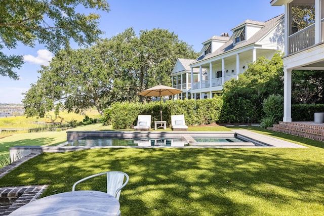 202 Bank St, Mount Pleasant, SC 29464 - rear view of house featuring a lawn and a pool with connected hot tub
