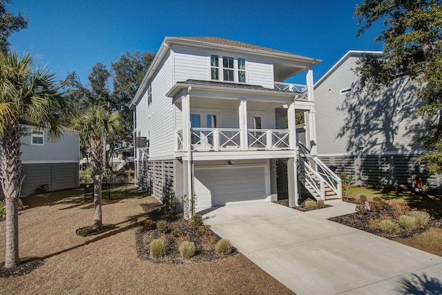 coastal inspired home featuring a porch and a garage