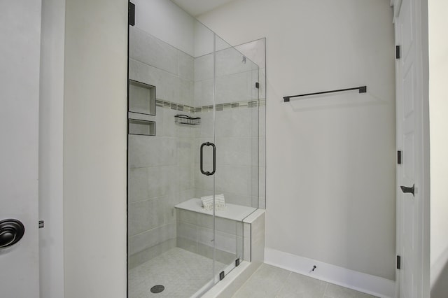 bathroom with tile patterned flooring and an enclosed shower