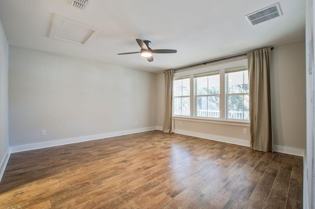 spare room with ceiling fan and dark hardwood / wood-style flooring