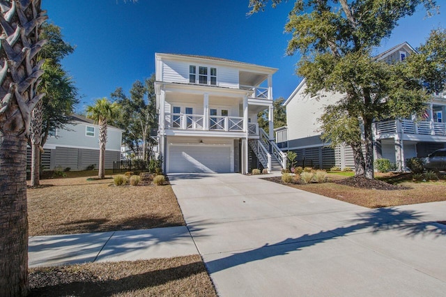 coastal inspired home featuring covered porch and a garage