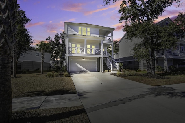 view of front facade featuring a garage, a balcony, and a porch