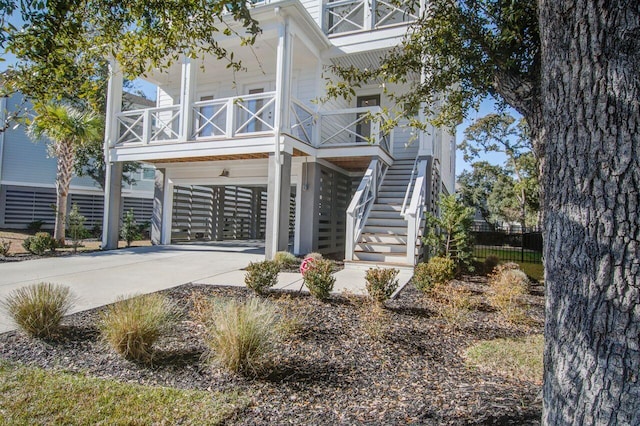 raised beach house featuring a carport and a porch