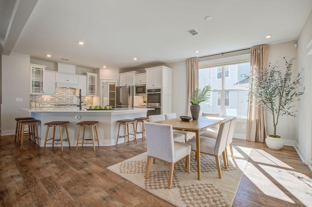 dining space with hardwood / wood-style floors