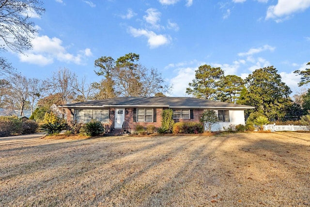 ranch-style home featuring a front yard