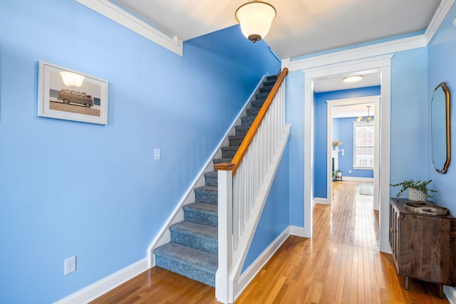stairs featuring baseboards and wood-type flooring