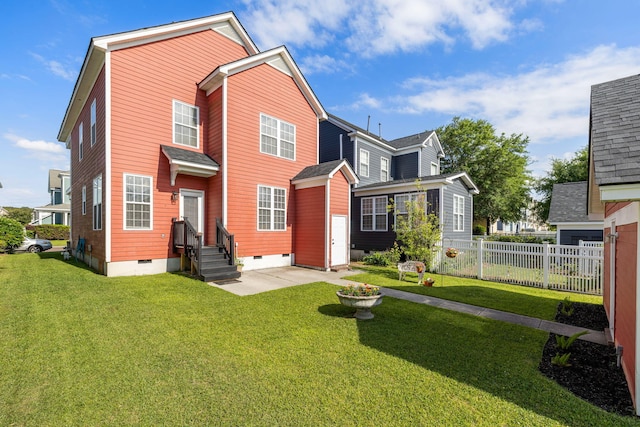 back of property featuring a lawn, crawl space, and fence