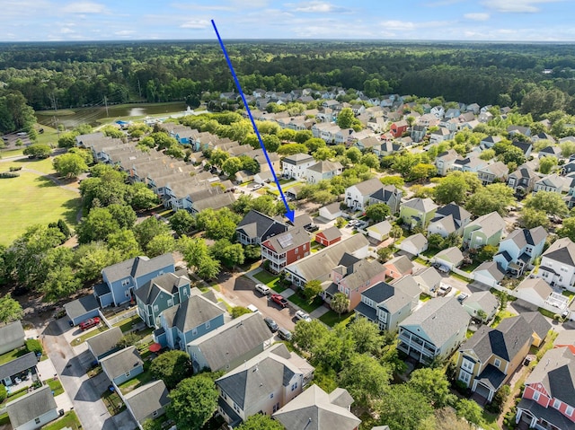 bird's eye view featuring a residential view and a wooded view