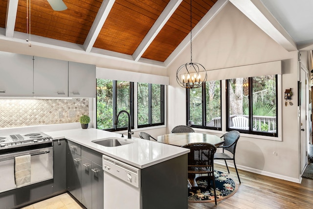 kitchen with beam ceiling, decorative light fixtures, dishwasher, range with gas stovetop, and wooden ceiling