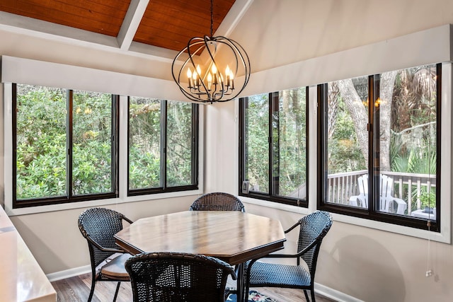 dining area featuring wooden ceiling, hardwood / wood-style flooring, an inviting chandelier, and a healthy amount of sunlight