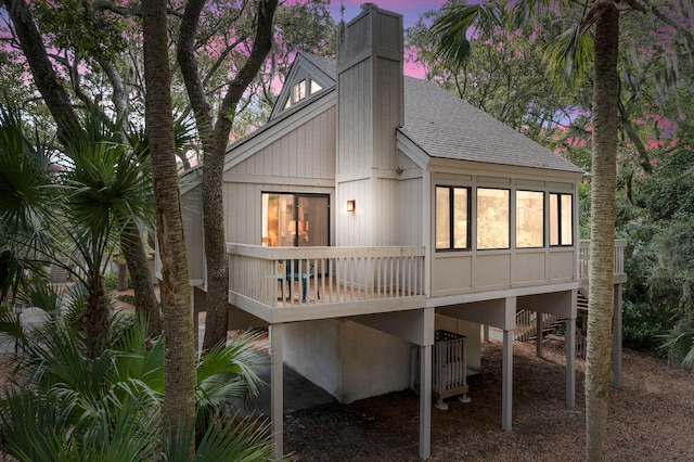 view of back house at dusk