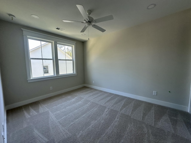 carpeted empty room featuring ceiling fan