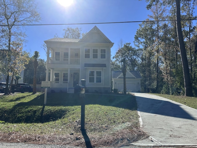 view of front of house with a balcony and a front lawn