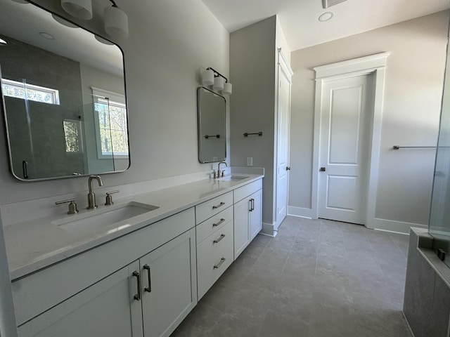 bathroom featuring walk in shower and vanity