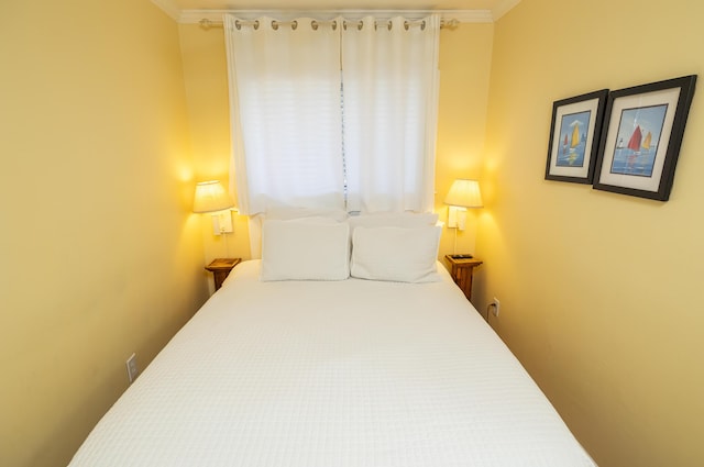 bedroom with ornamental molding