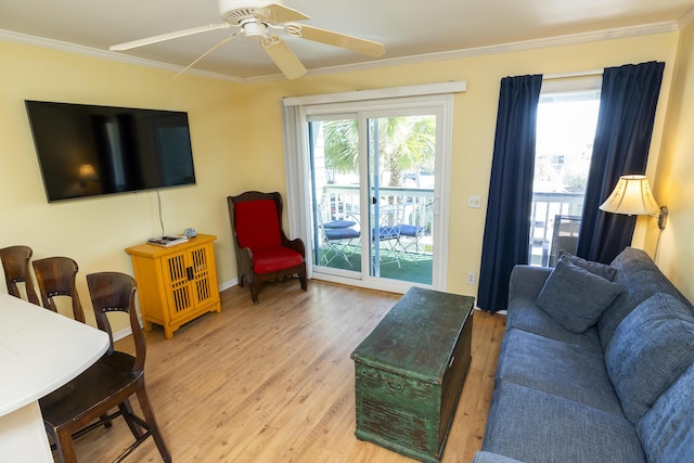 living room featuring crown molding, wood finished floors, and ceiling fan