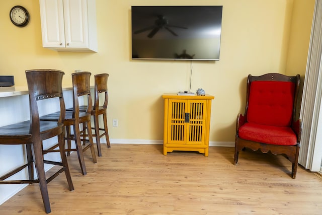 living area with light wood finished floors and baseboards