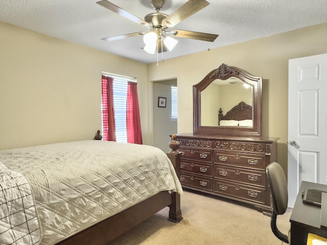 bedroom with light carpet, a textured ceiling, and a ceiling fan