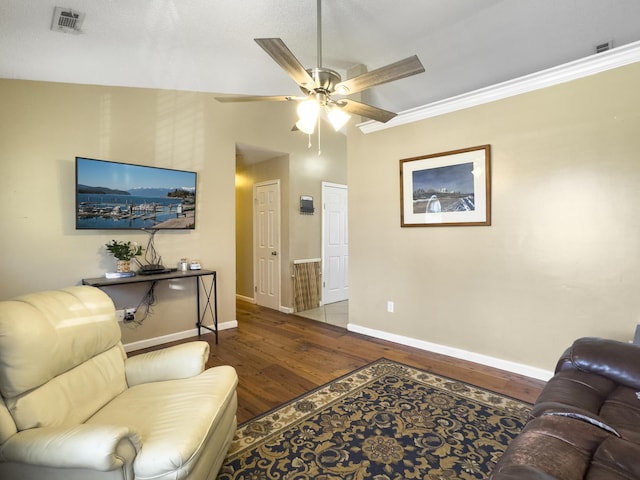 living area with lofted ceiling, visible vents, ceiling fan, wood finished floors, and baseboards