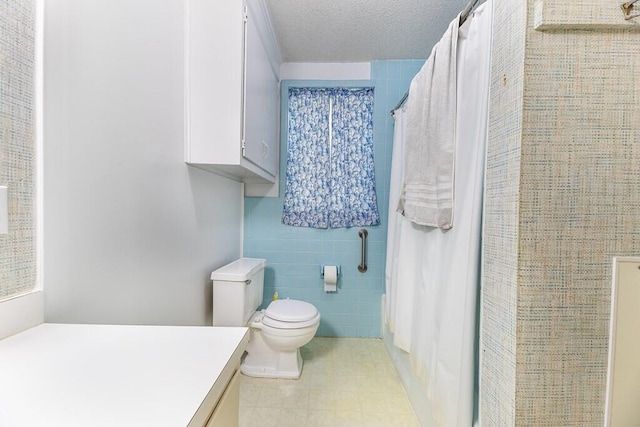 full bath featuring toilet, tile walls, vanity, and a shower with shower curtain