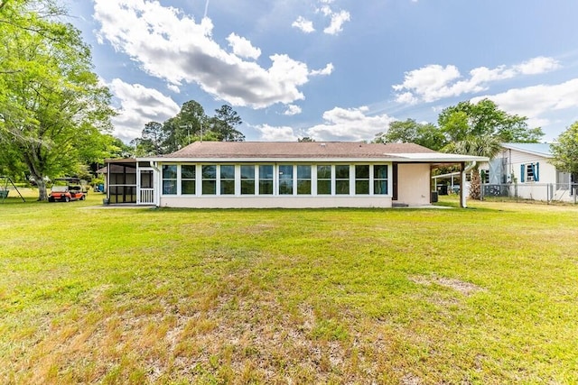 back of house with a sunroom, a yard, and fence