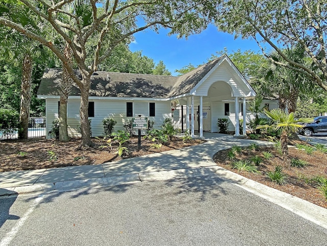 5226 Fernland Way N, Charleston, SC 29420 - view of front facade featuring a porch, a shingled roof, fence, and a carport