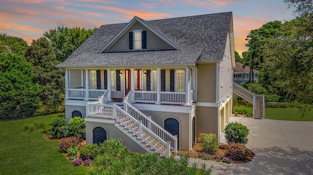 view of front of home featuring a porch and a yard