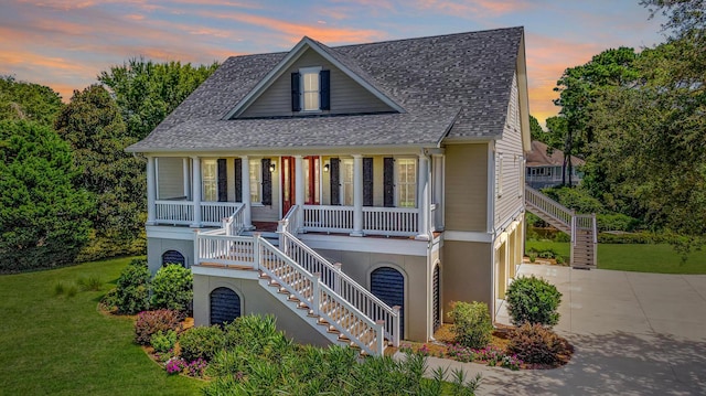 view of front of home featuring a porch and a yard