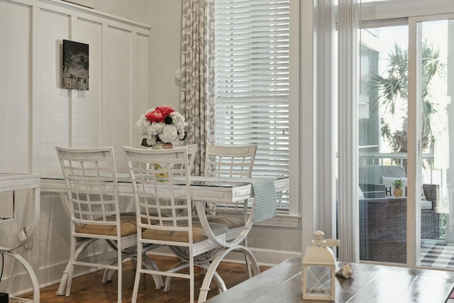 dining space with wood-type flooring