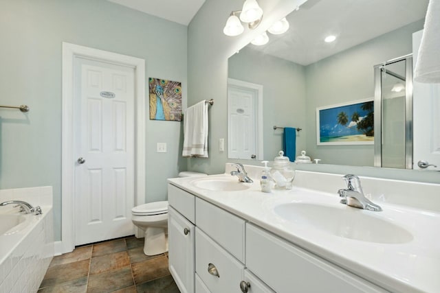 bathroom featuring a relaxing tiled tub, toilet, and vanity