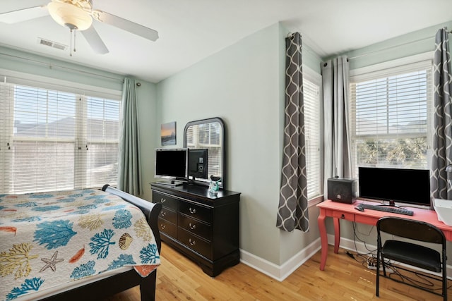 bedroom with light hardwood / wood-style floors, multiple windows, and ceiling fan