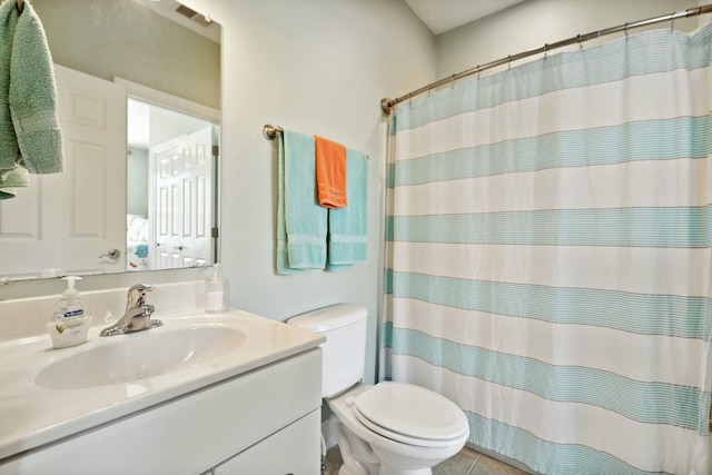 bathroom featuring tile patterned flooring, vanity, toilet, and curtained shower