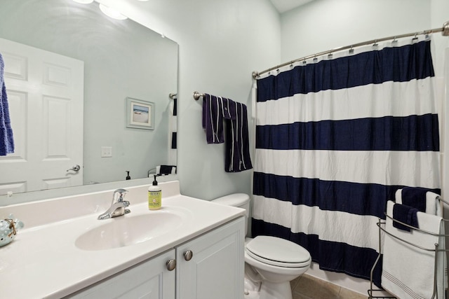 bathroom featuring tile patterned floors, curtained shower, vanity, and toilet