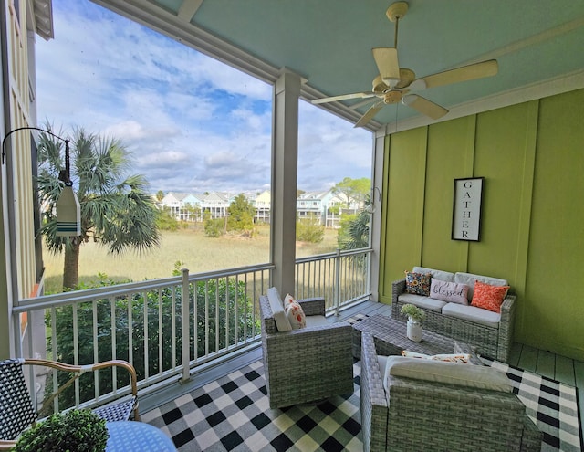 sunroom / solarium featuring ceiling fan