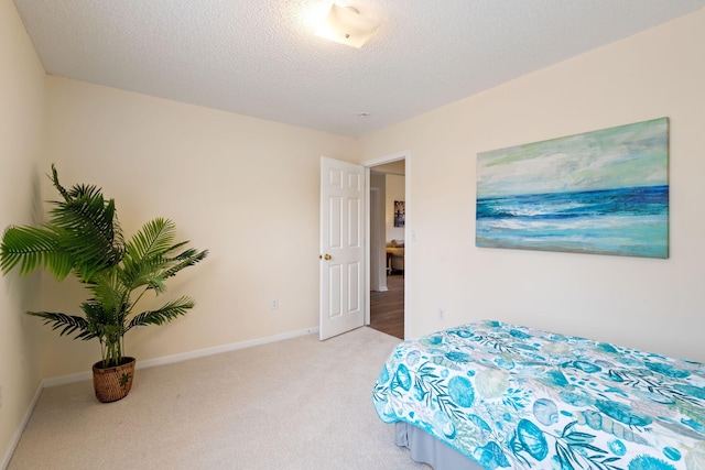 carpeted bedroom with a textured ceiling