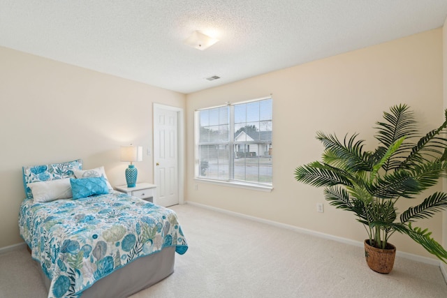 carpeted bedroom with a textured ceiling