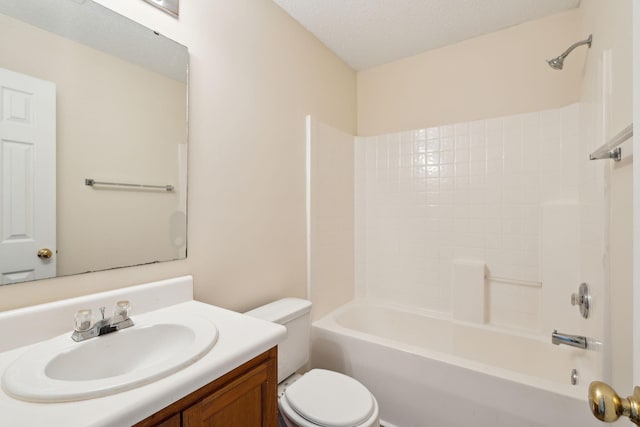 full bathroom featuring toilet, vanity, a textured ceiling, and washtub / shower combination