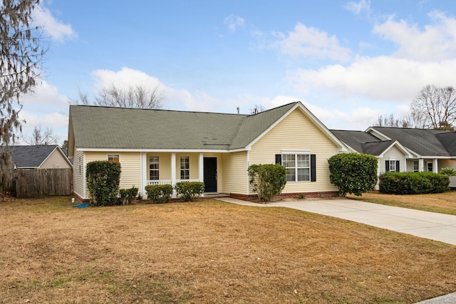 single story home with a porch and a front lawn