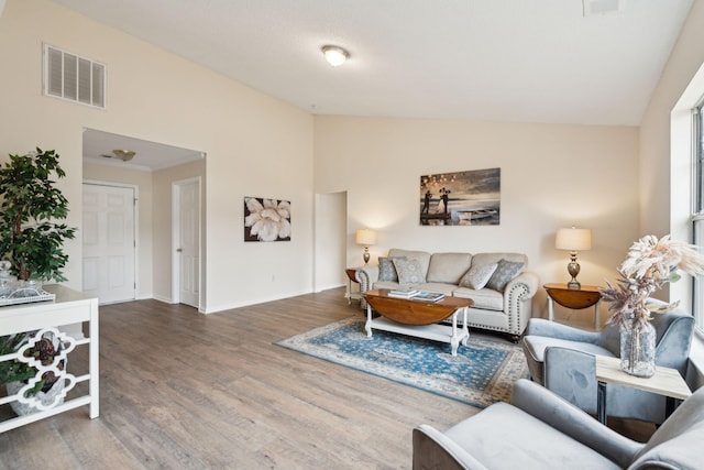 living room featuring dark hardwood / wood-style floors and vaulted ceiling