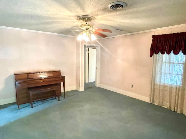 miscellaneous room featuring ceiling fan, crown molding, a textured ceiling, and carpet floors