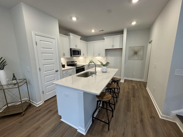 131 Brown Swiss Cir, Summerville, SC 29483 - kitchen featuring white cabinets, dark wood finished floors, a sink, and appliances with stainless steel finishes