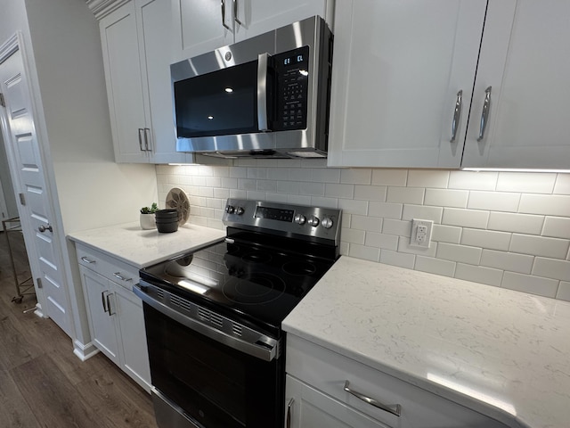 131 Brown Swiss Cir, Summerville, SC 29483 - kitchen with stainless steel microwave, dark wood-style flooring, black electric range oven, and backsplash