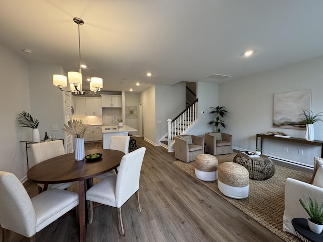 131 Brown Swiss Cir, Summerville, SC 29483 - dining space with stairs, dark wood-type flooring, baseboards, and an inviting chandelier
