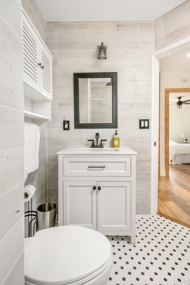 bathroom with vanity, tile patterned flooring, and tile walls