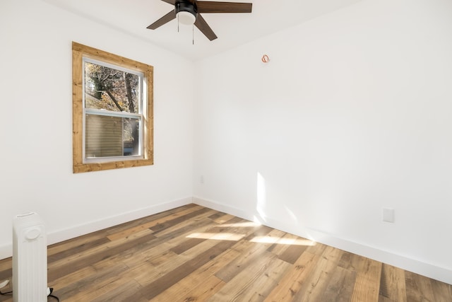 spare room featuring hardwood / wood-style flooring and ceiling fan